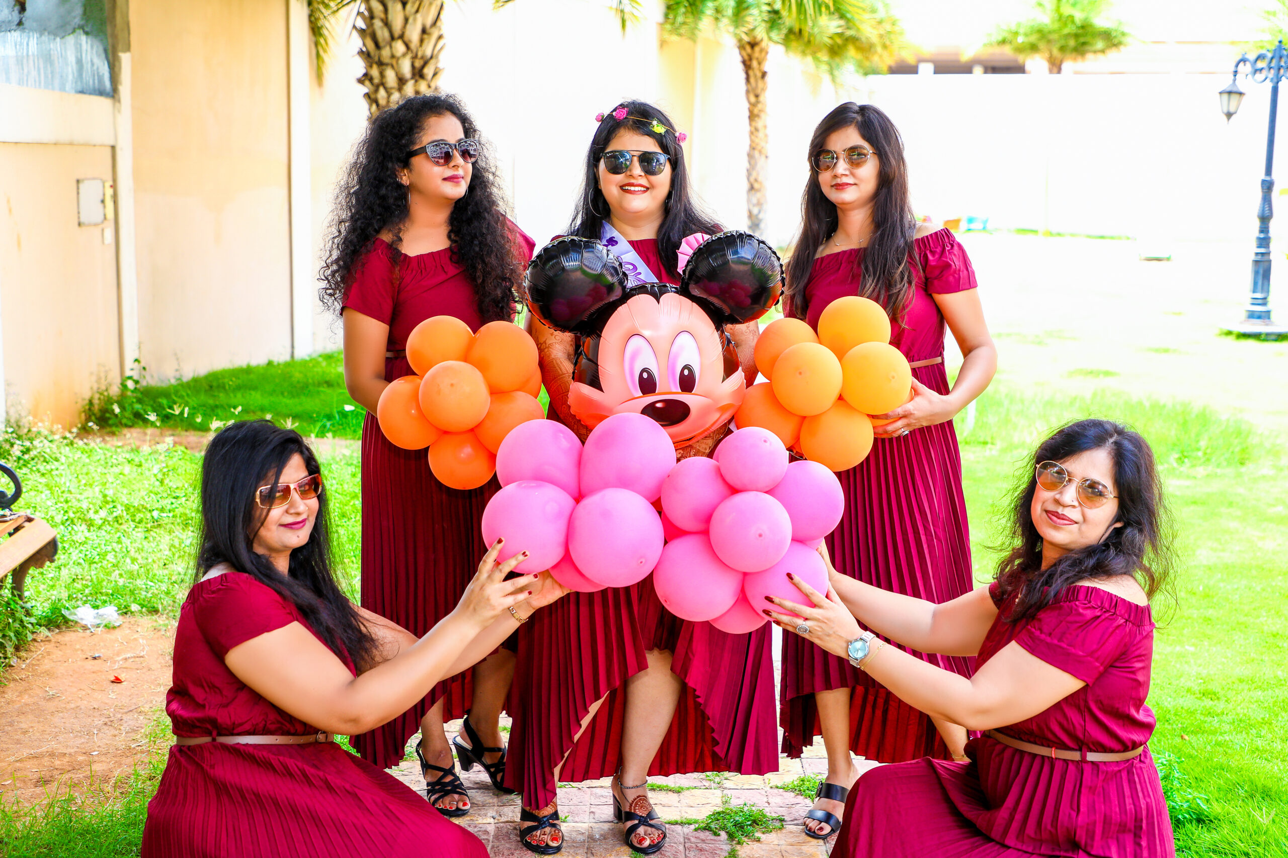 Women posing with balloons in a maternity shoot by AK Photography Coimbatore
